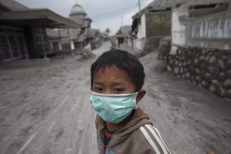 People clear volcanic ash in Indonesia