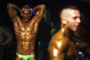 Bodybuilders prepare backstage before competition