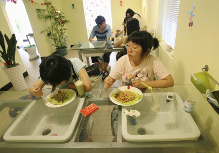 Diners eat at a toilet-themed restaurant in Hangzhou