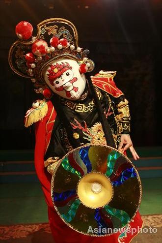 Opera performer demonstrates face-changing stunt