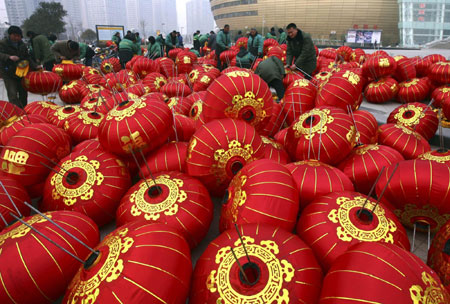 Workers prepare red lantern decorations for the Lantern Festival in Zhengzhou