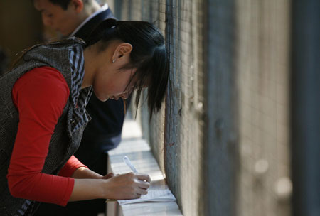 A job seeker fills in an application forms at a 'talent market' <BR>