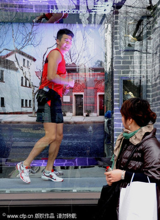 Model jogges in window to promte a healthy workout