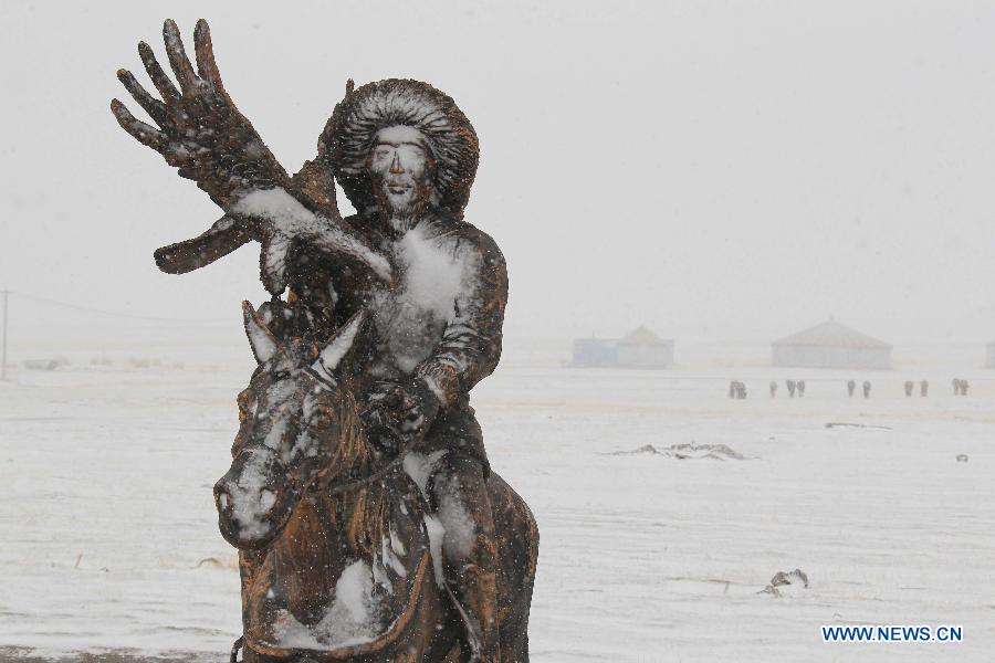 Spring snow falls on grassland in NW China