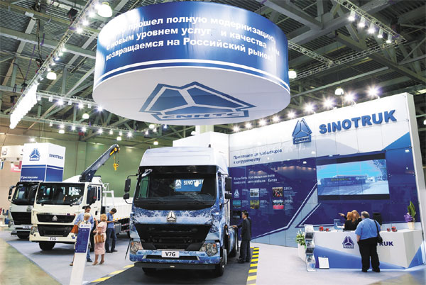 Visitors check Sinotruk’s vehicles displayed at a construction and machinery exhibition in Russia in 2015