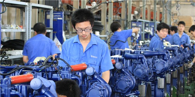 Workers operate an engine production line in Weichai Power