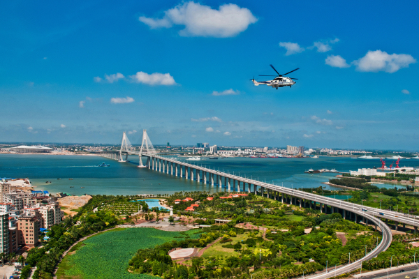 Helicopter flies over a cross-sea bridge in Zhanjiang