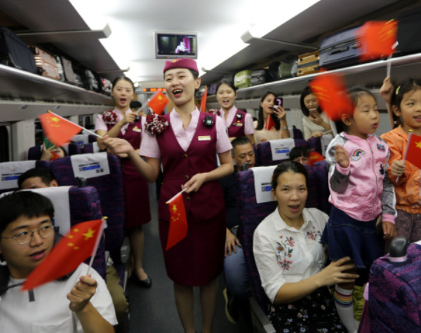 Passengers take the first high-speed train from Fuzhou to Hong Kong