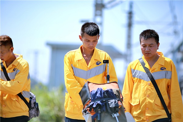 Workers carry out rail inspection under scorching heat