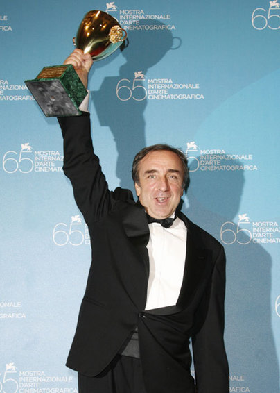 Orlando holds Coppa Volpi trophy for Best Actor at Venice