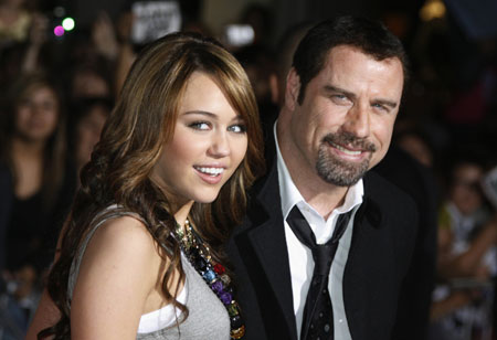 Cyrus, Travolta pose at the premiere animated film 