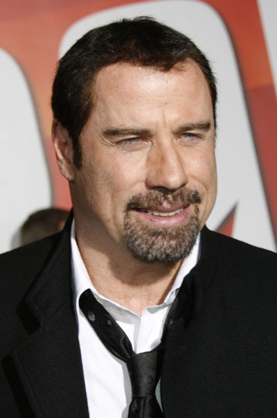 Cyrus, Travolta pose at the premiere animated film 