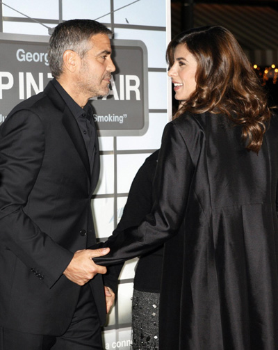 George Clooney and his girlfriend pose at the premiere of 
