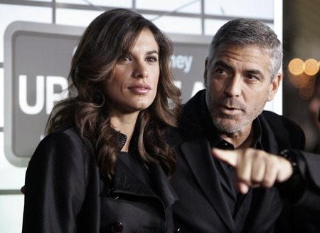 George Clooney and his girlfriend pose at the premiere of 