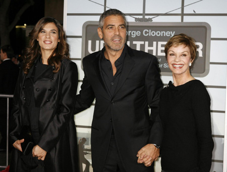 George Clooney and his girlfriend pose at the premiere of 