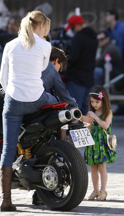 Tom Cruise holds Suri during a break in filming in Seville