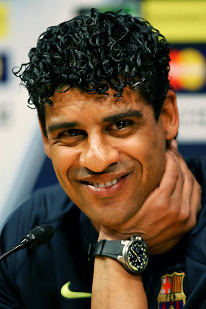 Barcelona's coach Frank Rijkaard smiles during a news conference before a training session at Nou Camp Stadium in Barcelona, Spain March 6, 2006. Barcelona and Chelsea will play their Champions League first knockout round return leg soccer match on March 7.