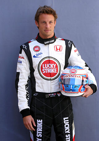 Honda Formula One driver Jenson Button of Britain poses for photographs in the paddocks at the Sakhir race track for the Bahrain Formula One Grand Prix in Manama, Bahrain March 9, 2006. [Reuters]