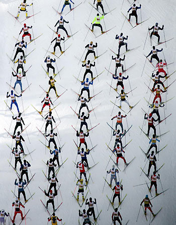 An aerial view of cross country skiers climbing a hill during the Engadin Ski Marathon near Sils, Switzerland, March 12, 2006. Approximately 12,000 skiers participated in the 42.2 km (26 miles) race between Maloja and S-chanf near the Swiss mountain resort of St. Moritz. [Reuters]