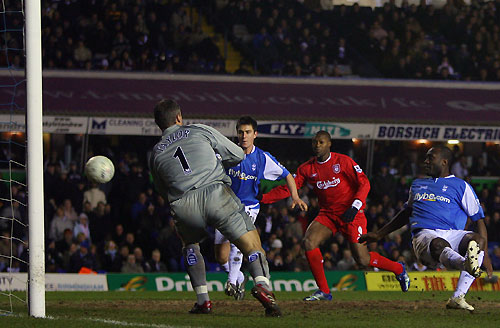Birmingham City's Olivier Tebily (R) scores an own goal past Maik Taylor (L) as