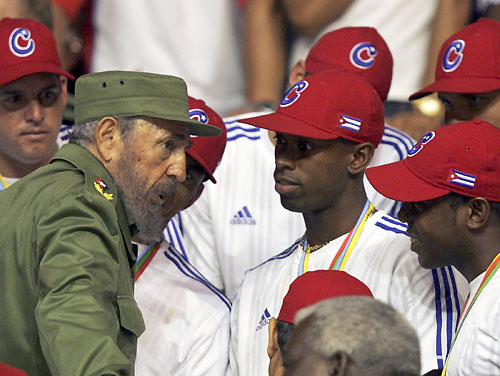 Cuban President Fidel Castro (L) talks to players of the Cuban baseball team in Havana March 21, 2006. Cuba gave its baseball team a hero's welcome on Tuesday and said the runner-up prize money from the World Baseball Classic would go to victims of Hurricane Katrina in the U.S. [Reuters]
