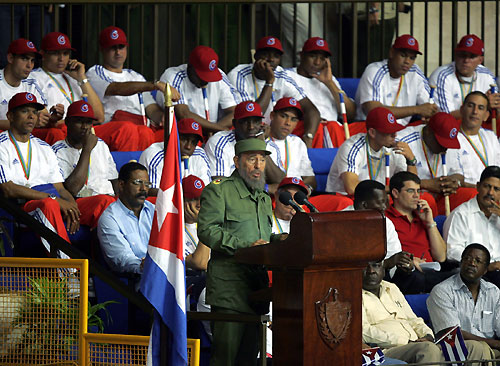 Cuban President Fidel Castro (L) talks to players of the Cuban baseball team in Havana March 21, 2006. Cuba gave its baseball team a hero's welcome on Tuesday and said the runner-up prize money from the World Baseball Classic would go to victims of Hurricane Katrina in the U.S. [Reuters]