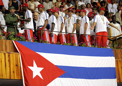 Cuban President Fidel Castro (L) talks to players of the Cuban baseball team in Havana March 21, 2006. Cuba gave its baseball team a hero's welcome on Tuesday and said the runner-up prize money from the World Baseball Classic would go to victims of Hurricane Katrina in the U.S. [Reuters]