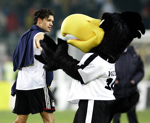Germany's Michael Ballack looks at team mascot 'Paule' after a 