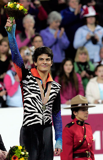 Switzerland's Stephane Lambiel celebrates his gold medal win at the World Figure Skating Championships in Calgary, Canada, March 23, 2006. [Reuters]