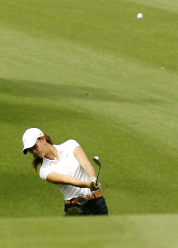 Michelle Wie of the U.S. hits her second shot on the fourth hole at the LPGA Kraft Nabisco Championships golf tournament in Rancho Mirage, California March 30, 2006.
