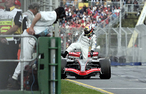 McLaren Formula One driver Juan Pablo Montoya gets out of his car next to pit lane after retiring from the Australian Grand Prix in Melbourne 