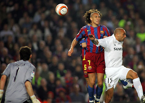 Real Madrid's goalkeeper Iker Casillas (L) looks as his team mate Raul Bravo (R) jumps for the ball against Barcelona's Henrik Larsson of Sweden (2nd R) and Puyol during the Spanish first division soccer match at Nou Camp stadium in Barcelona, Spain April 1, 2006. [Reuters]