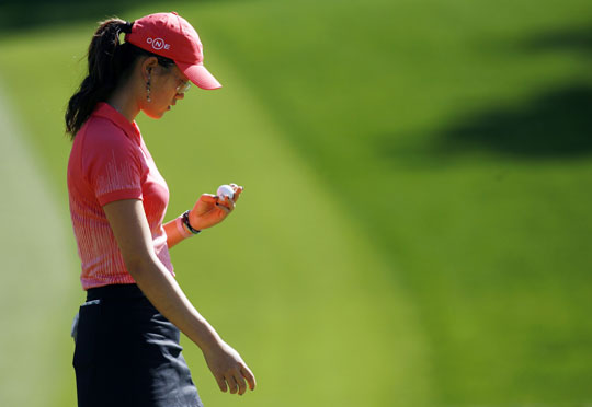 Michelle Wie of the U.S. looks down at her ball after putting for a birdie on the first hole at the Kraft Nabisco Championship golf tournament in Rancho Mirage, California, April 2, 2006. [Reuters]