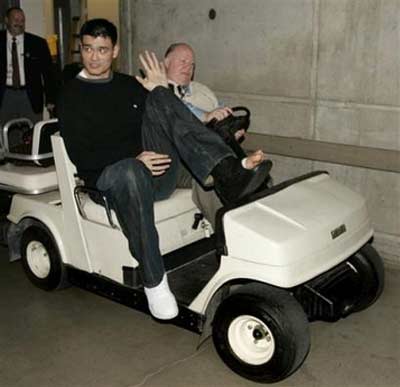 Houston Rockets center Yao Ming, of China, leaves the locker room after his team's NBA basketball game against the Utah Jazz on Monday, April 10, 2006, in Salt Lake City. Yao broke his left foot in the first quarter. The Jazz beat the Rockets, 85-83. [AP Photo] 