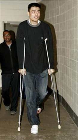 Houston Rockets center Yao Ming, of China, leaves the locker room after his team's NBA basketball game against the Utah Jazz on Monday, April 10, 2006, in Salt Lake City. Yao broke his left foot in the first quarter. The Jazz beat the Rockets, 85-83. [AP Photo] 