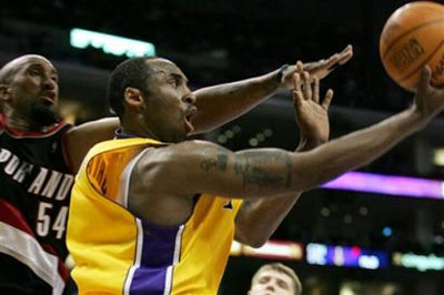 Los Angeles Lakers' Kobe Bryant goes up for a shot while being guarded by Portland Trail Blazers' Brian Skinner during the second half of an NBA basketball game Friday, April 14, 2006, in Los Angeles. [AP]