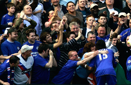  Drogba celebrates with fans after scoring against Everton during their English Premier League soccer match at Stamford 