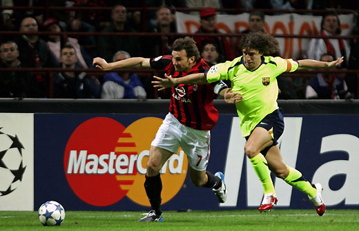 Andriy Shevchenko (L) fights for the ball against Barcelona's player Carles Puyol