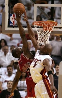 Miami Heat's Dwyane Wade (3) blocks a shot by Chicago Bulls' Ben Gordon (9) during the fourth quarter of an NBA basketball first-round playoff game in Miami Monday, April 24, 2006. 