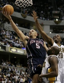 New Jersey Nets' Jason Kidd (5) puts up a shot against Indiana Pacers' Anthony Johnson, center, and Fred Jones during the third quarter of an NBA first-round playoff basketball game in Indianapolis, Saturday, April 29, 2006.