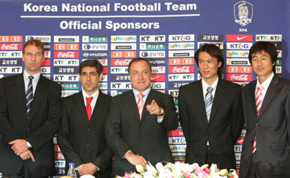 The Netherlands' Dick Advocaat, head coach of the South Korean national soccer team, poses with his coaching staff Pim Verbeek, Afshin Ghotbi, Hong Myung-bo and Chung Gi-dong (L-R) after announcing his squad for the 2006 Germany World Cup, at a news conference in Seoul May 11, 2006. Advoccat named a balanced and versatile team on Thursday for next month's World Cup in Germany.