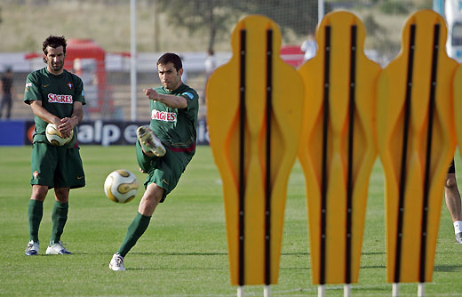 Portugal's Luis Figo (L) watches team mate Pauleta Resendes 