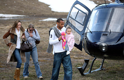 Thierry is accompanied by his daughter Tea (in arms) his wife Nicole Merry (L)