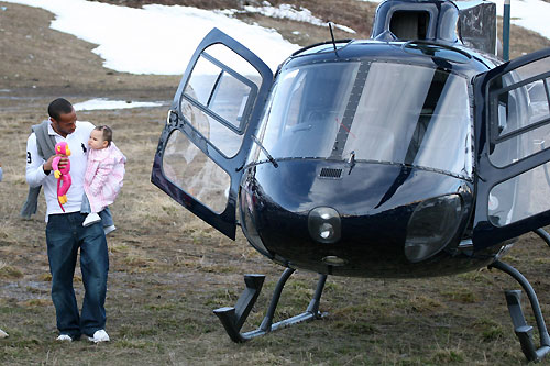 Thierry is accompanied by his daughter Tea (in arms) his wife Nicole Merry (L)