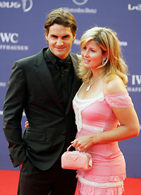 Swiss tennis player Roger Federer (L) and his girlfriend Miroslava Vavrinec arrive at the Laureus World Awards ceremony in Barcelona May 22, 2006. 
