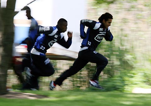 Ecuador soccer players Cristian Benitez (L) and Paul Ambrossi run during a practice session in New Jersey May 23, 2006. 