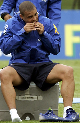 Brazilian soccer player Ronaldo eats an energy supplement after a soccer training session at Thermoplan Arena in the Swiss town of Weggis, Switzerland, May 25, 2006.
