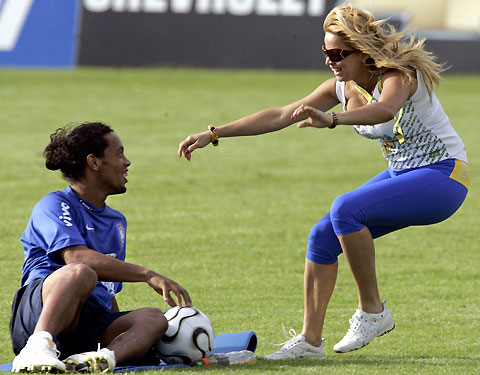 fan runs onto the pitch to embrace Brazilian striker Ronaldinho (L) during a training session at Thermoplan Arena in Weggis, Switzerland, May 26, 2006.