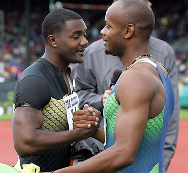 Justin Gatlin (L) of the United States and Asafa Powell of Jamaica congratulate each other after winning separate 100 meter dash races at the Prefontaine Classic in Eugene, Oregon May 28, 2006. Gatlin and Powell share the world record of 9.77 seconds for the 100 meter dash, but neither surpassed that time at the meet.