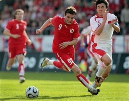 Switzerland's Alex Frei, left, and China's Li Weifeng, right, fight for the ball, during a test match between the national soccer teams of Switzerland and China, in Zurich, Switzerland, Saturday, June 3, 2006, ahead of the World Cup in Gemany. Switzerland will play in group G with France, Togo and South Korea. China is not qualified for the World Cup. 